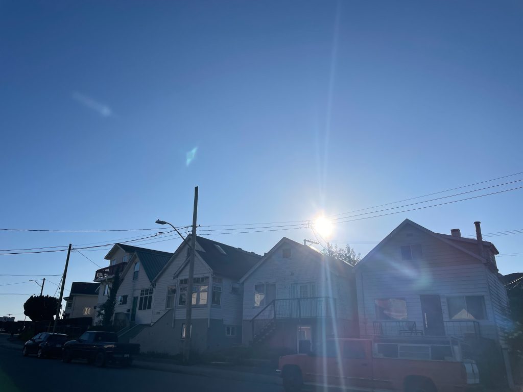 Sunlight filters over a row of homes in Prince Rupert, BC, on Coast Ts'msyen Territory.
