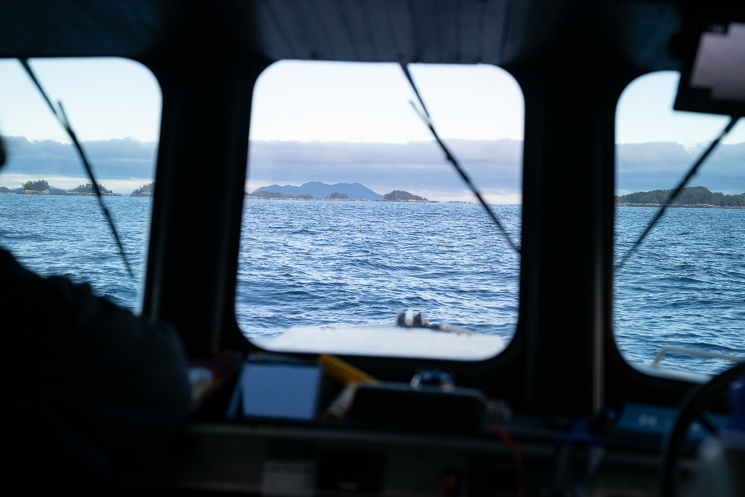 A view of the Pacific Ocean in Northern BC from inside the helm of a boat.