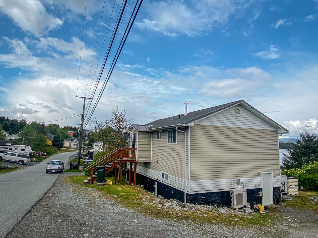 Remote home with a recently installed heat pump outside.