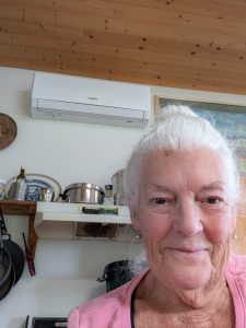 Marnie Crowe, a Sointula resident, with her newly installed heat pump after receiving support from Ecotrust Canada. (Submitted photo)
