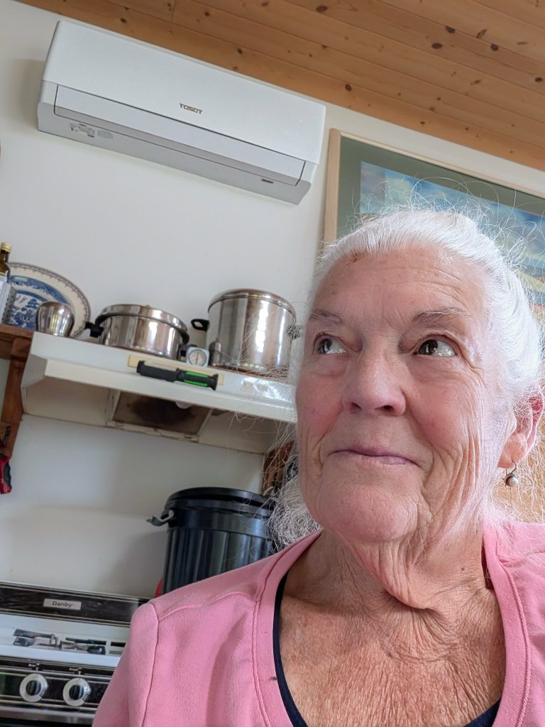 Marnie Crowe, a Sointula resident, with her newly installed heat pump after receiving support from Ecotrust Canada. (Submitted photo)
